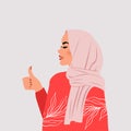 Beautiful muslim woman raise her thumbs up as symbol of approval.