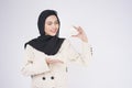 Young beautiful muslim woman in suit holding small model house over white background studio Royalty Free Stock Photo