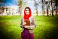 Beautiful muslim woman wearing hijab and holding a holy book Koran. Royalty Free Stock Photo