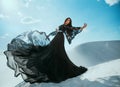 Beautiful mysterious Arab woman queen in black clothes. Girl fashion model posing, dancing in long, silk dress, fabric Royalty Free Stock Photo