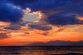 Beautiful mysterious dramatic romantic colorful red orange blue sun dusk sunset on Ionian Sea on island sand beach. Twilight glow. Royalty Free Stock Photo