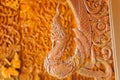 Beautiful Naga teak wood carving sculptures in Thai temple.