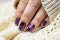 Beautiful nail polish in hand, purple nail art manicure, white background Royalty Free Stock Photo