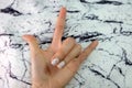 Beautiful Nail Polish, Manicure Nail. Close Up Granite Gray Nails on the Granite Stone Fabric