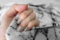 Beautiful Nail Polish, Manicure Nail. Close Up Granite Gray Nails on the Granite Stone Fabric