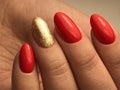 Beautiful nails with red and gold gel polish macro Royalty Free Stock Photo