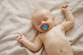 a beautiful naked baby with nipple sleeps on the bed. Royalty Free Stock Photo
