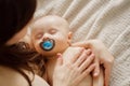 a beautiful naked baby with nipple sleeps in his mother& x27;s arms. Royalty Free Stock Photo