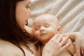 a beautiful naked baby sleeps in his mother& x27;s arms. the happiness of motherhood. Royalty Free Stock Photo