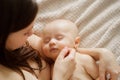 a beautiful naked baby sleeps in his mother& x27;s arms. the happiness of motherhood. Royalty Free Stock Photo