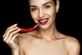 Beautiful naked seductive woman with red lips holding chili pepper Royalty Free Stock Photo