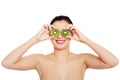 Beautiful naked woman with kiwi fruit on eyes. Royalty Free Stock Photo