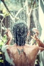 Beautiful naked young woman taking shower in bathroom outside on he luxury villa. Tropical Bali island, Indonesia. Royalty Free Stock Photo