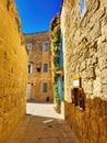 Beautiful narrow old street in mediterranean city. Beautiful scenic old ancient white houses with flowers. Staircase in the Royalty Free Stock Photo