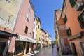 Beautiful narrow street with ancient building facades and paving stones in the coastal town of Rovinj, Croatia Royalty Free Stock Photo