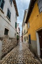 Beautiful narrow street with ancient building facades and paving stones in the coastal town of Rovinj, Croatia Royalty Free Stock Photo