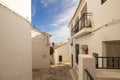 Beautiful narrow street with cobblestone stairs in an old town with white houses and tiled roofs. Altea, Spain Royalty Free Stock Photo