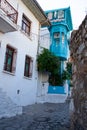 Beautiful narrow street in old town of Marmaris with plants and flowers on sunny day, Turkey. Blue balcony and door on Royalty Free Stock Photo