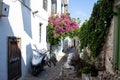 Beautiful narrow street in old town of Marmaris with plants and flowers on sunny day, Turkey. Blue balcony and door on Royalty Free Stock Photo