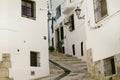 Beautiful narrow street in the old town with white houses and a cobblestone road. Altea, Spain Royalty Free Stock Photo