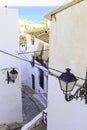 Beautiful narrow street in the old town with white houses and a cobblestone road. Altea, Spain Royalty Free Stock Photo