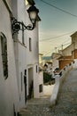 Beautiful narrow street in the old town with white houses and a cobblestone road. Altea, Spain Royalty Free Stock Photo