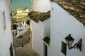 Beautiful narrow street in the old town with white houses and a cobblestone road. Altea, Spain Royalty Free Stock Photo