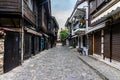 Beautiful and narrow street with restaurants, cafes and shops of the ancient seaside town.