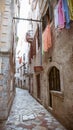 Beautiful narrow streets of the old European city. stone paved paths. Residents people dry their clothes on the windows