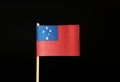 A beautiful national Flag of Samoa on wooden stick on black background. Another state belongs to oceania.