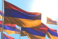 Beautiful national holiday flag 3d illustration - many Armenia flags are wave against blue sky picture with bokeh