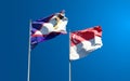 Beautiful national state flags of Singapore and American Samoa together at the sky background