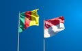 Beautiful national state flags of Singapore and Cameroon together at the sky background. 3D artwork concept