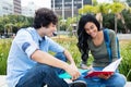 Beautiful native latin american student learning with friend Royalty Free Stock Photo