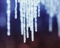 Beautiful natural background with shiny transparent icicles hanging in spring Sunny day Royalty Free Stock Photo