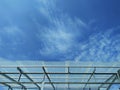 White clouds in blue sky with transparent plastic roof.
