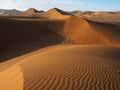 Beautiful natural curved ridge line and wind blow pattern of rusty red sand dune valley with shade and shadow on desert landscape Royalty Free Stock Photo