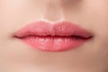 Beautiful natural female lips close-up with pink permanent makeup stick