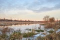 Beautiful natural landscape with birch and frozen river in winter.