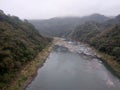 Beautiful natural landscape featuring a river in the middle of mountains Royalty Free Stock Photo