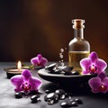 Beautiful natural pink orchid flowers, black massage stones and bottles of aromatic oil on the dark background of the spa salon Royalty Free Stock Photo