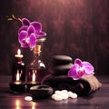 Beautiful natural pink orchid flowers, black massage stones and bottles of aromatic oil on the dark background of the spa salon Royalty Free Stock Photo