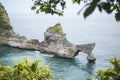 Beautiful Natural Rock Arch Island in the Sea at Atuh Beach in Nusa Penida, Bali, Indonesia. Aerial View.