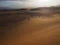 Beautiful natural rusty red sand dune and salt pan of vast desert landscape with strong sunlight, Sossus, Namib desert