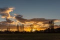 Sunset, sun setting behind trees countryside, grassland Royalty Free Stock Photo