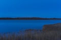 Beautiful nature and landscape photo of blue dusk evening at lake in Sweden Scandinavia Royalty Free Stock Photo