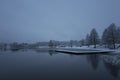 Beautiful nature and landscape photo of snowy blue dusk evening and wooden bridge in Katrineholm Sweden Scandinavia Royalty Free Stock Photo