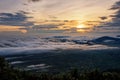 Beautiful nature landscape the sun is above the sea fog that covers the mountains and bright sky during sunrise in the winter at Royalty Free Stock Photo