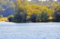 A landscape view of a lake in the Kent countryside with trees and sky in the background . Royalty Free Stock Photo