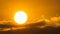 Beautiful nature morning with orange, yellow sunshine and fluffy clouds. Time lapse of a beautiful dramatic sky with a big sun at Royalty Free Stock Photo